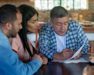 Man discussing finanical plans with his children.